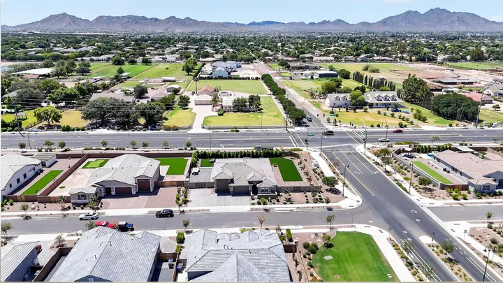 Drone photo of a neighborhood with mountains on the horizon