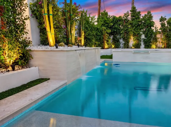 Backyard pool with spa at twilight